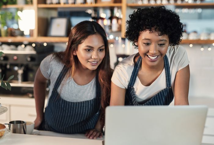 Small business owner using a laptop to manage online orders and digital marketing.